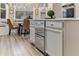 Kitchen island featuring stainless steel appliances and extra storage, with a breakfast nook surrounded by natural light at 4560 Evandale Way, Cumming, GA 30040