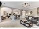 Open concept living room with plush carpet, arched entryways, and seamlessly connected to the kitchen and dining areas at 4560 Evandale Way, Cumming, GA 30040