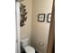 Well-lit half bathroom featuring decor accents and standard toilet at 6311 Olmadison Pl, Atlanta, GA 30349
