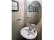 Cozy powder room with modern oval mirror and a stylish vessel sink at 6311 Olmadison Pl, Atlanta, GA 30349