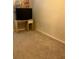 Small bedroom includes a desk, TV and light-colored carpet at 6311 Olmadison Pl, Atlanta, GA 30349