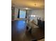 Bright living room with dark wood floors, glass dining table, and stylish decor at 6311 Olmadison Pl, Atlanta, GA 30349