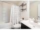 Bathroom featuring a shower-tub combo with a white and grey curtain and vanity with storage at 7701 Haynes Park Pl, Lithonia, GA 30038