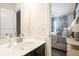 Modern bathroom with a sleek vanity and mirror, seamlessly connected to the elegant Primary bedroom at 7701 Haynes Park Pl, Lithonia, GA 30038