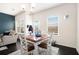 Cozy dining area with large windows, hardwood floors, and view of the living area at 7701 Haynes Park Pl, Lithonia, GA 30038