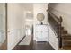 Inviting entryway with hardwood floors, decorative cabinet, staircase, and modern decor at 7701 Haynes Park Pl, Lithonia, GA 30038