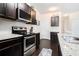 Modern kitchen with stainless steel appliances, subway tile backsplash, and granite countertops at 7701 Haynes Park Pl, Lithonia, GA 30038