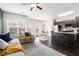 Open-concept living room with lots of natural light and modern decor connecting to the kitchen and dining area at 7701 Haynes Park Pl, Lithonia, GA 30038