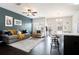 Bright living area with dark accent wall, plush seating, and open layout at 7701 Haynes Park Pl, Lithonia, GA 30038