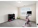 Bright exercise room with carpeted floors, natural light, a stationary bike, and weight storage for a home gym at 7701 Haynes Park Pl, Lithonia, GA 30038