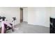 Workout area with a pink stationary bike, weight rack, and large window, perfect for staying active at home at 7701 Haynes Park Pl, Lithonia, GA 30038