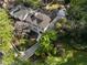 Aerial view of a charming home with dark roof, adjacent garage, mature trees at 1503 Emory Ne Rd, Atlanta, GA 30306