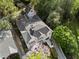 Aerial view of a home with a dark roof, matching garage, and lush greenery at 1503 Emory Ne Rd, Atlanta, GA 30306