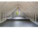 Bright and spacious attic featuring a high ceiling, exposed beams, and natural light, offering potential at 1503 Emory Ne Rd, Atlanta, GA 30306