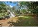 Spacious backyard with a white shed, grass lawn, and mature trees create a serene outdoor space at 1503 Emory Ne Rd, Atlanta, GA 30306