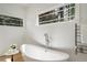 Bathroom featuring a modern soaking tub, heated towel rack, and views of the outdoors at 1503 Emory Ne Rd, Atlanta, GA 30306