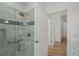 Bathroom featuring a glass enclosed shower with white and blue tiling and a grab bar at 1503 Emory Ne Rd, Atlanta, GA 30306