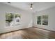 Bright bedroom with hardwood floors, a ceiling fan, and two large windows, providing a comfortable retreat at 1503 Emory Ne Rd, Atlanta, GA 30306