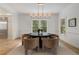 Bright dining room features a modern light fixture, four chairs, and windows offering views of the outdoors at 1503 Emory Ne Rd, Atlanta, GA 30306