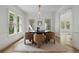 Bright dining room featuring modern lighting, neutral colors, and walls of windows at 1503 Emory Ne Rd, Atlanta, GA 30306