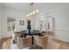 Dining room featuring a round table, four chairs, a stylish light fixture, and hardwood floors at 1503 Emory Ne Rd, Atlanta, GA 30306