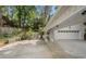 Long driveway with portico leading to the garage, with landscaped features and a garden pathway at 1503 Emory Ne Rd, Atlanta, GA 30306