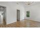 An empty room has great light, hardwood floors, a closet, and a door to another room at 1503 Emory Ne Rd, Atlanta, GA 30306