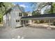 White brick home with a covered portico connecting the house to a garage in a beautiful setting at 1503 Emory Ne Rd, Atlanta, GA 30306