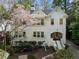 Charming two-story home with a well-maintained lawn, mature trees, and blooming dogwood at 1503 Emory Ne Rd, Atlanta, GA 30306