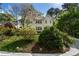 Beautiful two story home with white painted brick and lush green landscaping at 1503 Emory Ne Rd, Atlanta, GA 30306