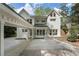 Rear exterior view of a white brick home with a covered portico, complemented by natural light at 1503 Emory Ne Rd, Atlanta, GA 30306