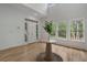 Bright foyer with hardwood floors, white walls, and tall windows overlooking the front yard at 1503 Emory Ne Rd, Atlanta, GA 30306