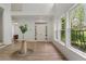 Bright foyer with hardwood floors, white walls, and tall windows overlooking the front yard at 1503 Emory Ne Rd, Atlanta, GA 30306