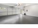 Clean garage with large roll up door, work space, and gray painted floor at 1503 Emory Ne Rd, Atlanta, GA 30306