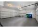 Spacious garage with shelving, overhead lighting, an automatic garage door, and storage cabinets at 1503 Emory Ne Rd, Atlanta, GA 30306