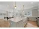 Open-concept kitchen with an island, farmhouse sink, and modern appliances, leading to the living area at 1503 Emory Ne Rd, Atlanta, GA 30306