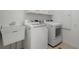 Functional laundry room with a utility sink, washer, and dryer, providing convenience for homeowners at 1503 Emory Ne Rd, Atlanta, GA 30306