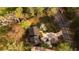 Aerial view of the property with a long driveway leading to a gray roofed home at 1718 Pucketts Sw Dr, Lilburn, GA 30047