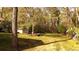 Large grassy backyard featuring a shed with picnic table and chairs, bordered by woods, creating a private and serene outdoor space at 1718 Pucketts Sw Dr, Lilburn, GA 30047