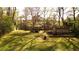 Home exterior with a sprawling backyard and mature trees on a sunny day at 1718 Pucketts Sw Dr, Lilburn, GA 30047