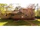 Backyard view of the rear of home with a wooden deck and green grass at 1718 Pucketts Sw Dr, Lilburn, GA 30047