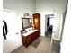 Bathroom featuring a sink, vanity, and a tall cabinet for storage at 1718 Pucketts Sw Dr, Lilburn, GA 30047