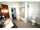 View of a bathroom featuring a toilet, shower/tub, and vanity with countertop at 1718 Pucketts Sw Dr, Lilburn, GA 30047
