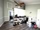 Bedroom with ceiling fan and shelving filled with shoes at 1718 Pucketts Sw Dr, Lilburn, GA 30047