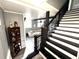 Inviting foyer featuring staircase with decorative wrought iron, an adjacent living room with a comfortable sofa at 1718 Pucketts Sw Dr, Lilburn, GA 30047