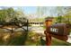 A beautiful home featuring a gated yard with fresh green grass and a quaint mailbox near the road at 1718 Pucketts Sw Dr, Lilburn, GA 30047