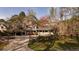 Charming two-story home featuring a covered carport, fenced yard, and a welcoming front porch at 1718 Pucketts Sw Dr, Lilburn, GA 30047