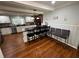 Bright kitchen features an island with barstool seating, white cabinets, and unique brick detail around stove at 1718 Pucketts Sw Dr, Lilburn, GA 30047
