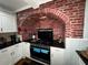 Kitchen features a brick archway over the stove, white cabinets, granite countertops, and stainless steel appliances at 1718 Pucketts Sw Dr, Lilburn, GA 30047
