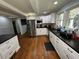 Modern kitchen with white cabinets, granite countertops, and stainless steel appliances for a sleek design at 1718 Pucketts Sw Dr, Lilburn, GA 30047
